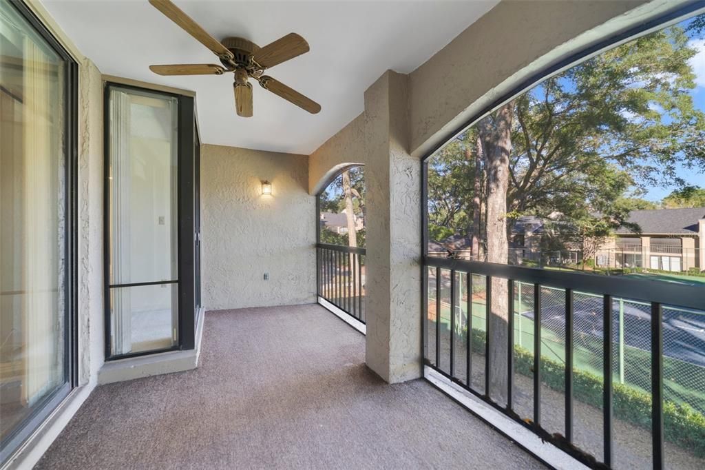 Screened and Covered Rear Patio Overlooks Tennis Courts and accesses Living Room and Primary Bedroom