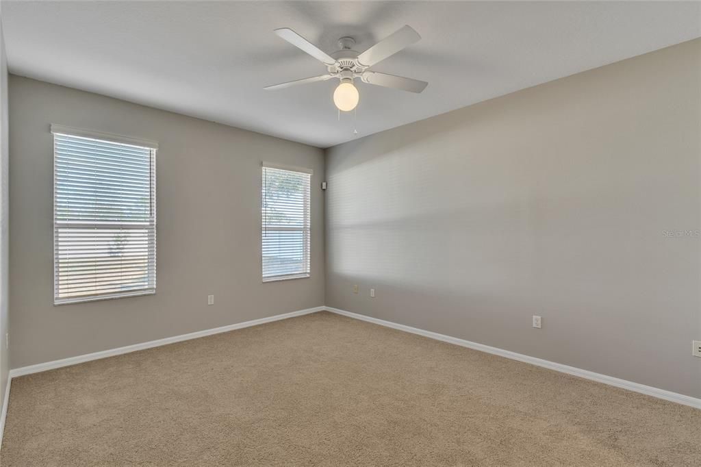 Primary Bedroom with window/view to backyard