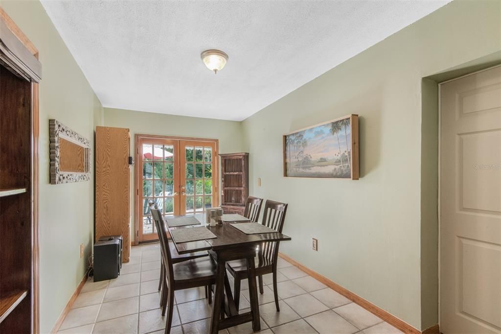 Large Open Dining Room With Wood French Doors To Patio