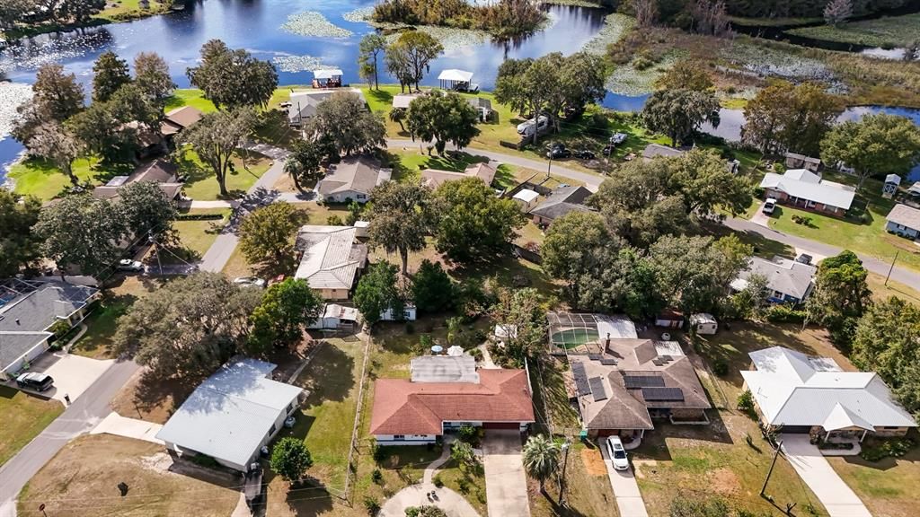 Aerial Front View of Home & Neighborhood & Surrounding Lake