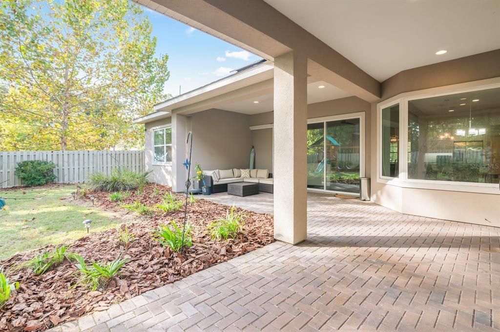 Large covered and pavered back patio