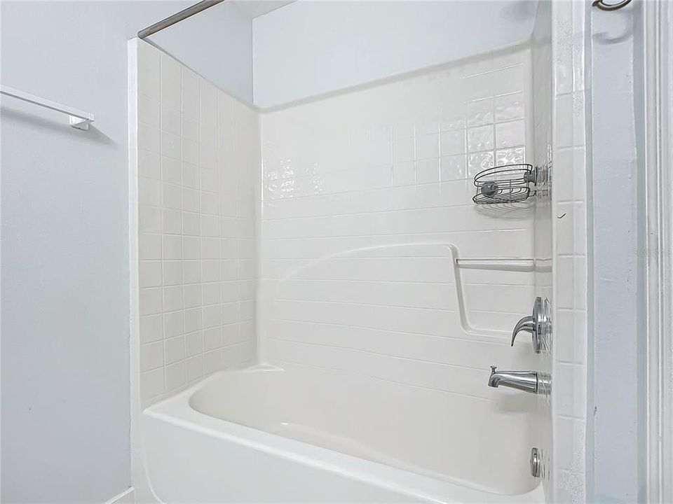 Bathroom 2:Fiberglass insert tub/shower, quartz counter and glass tile backsplash- Cultured Marble flooring