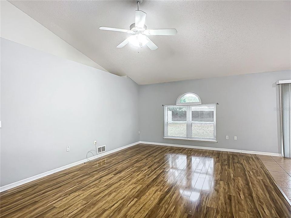 Family Room: Decorator Shelves - Fixed glass above double window -engineered flooring -Open to Breakfast Bar  kitchen and cafe nook