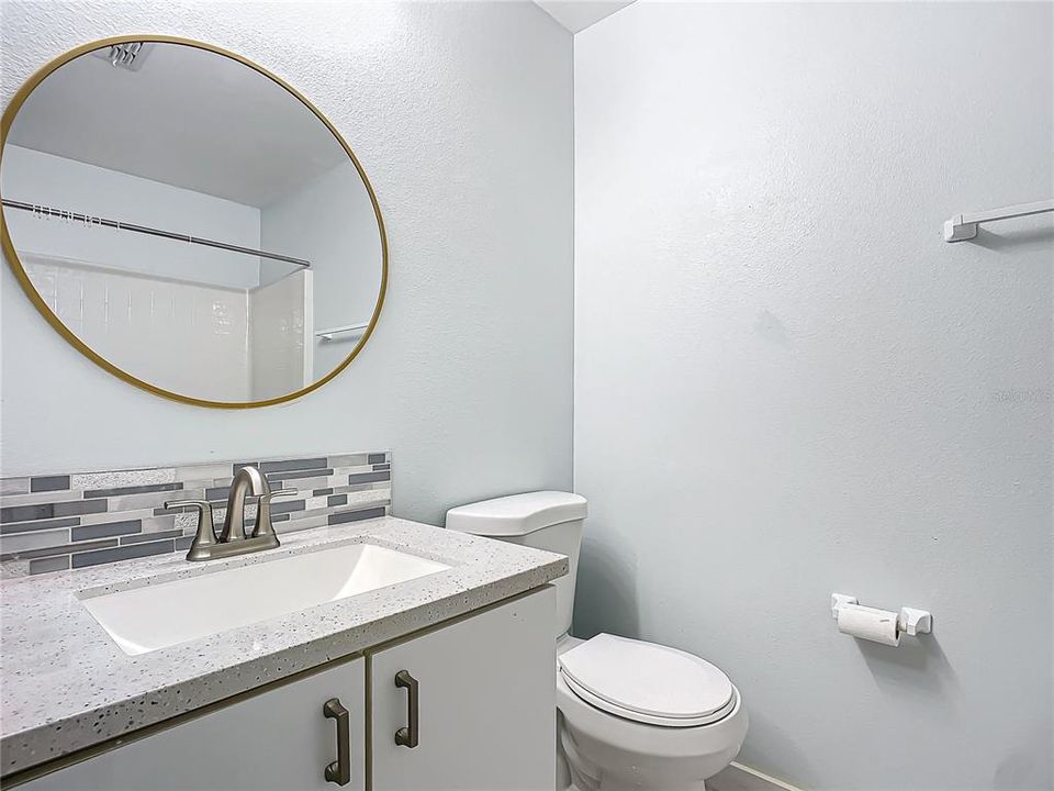 Bathroom 2: Fiberglass insert tub/shower, quartz counter and glass tile backsplash- Cultured Marble flooring