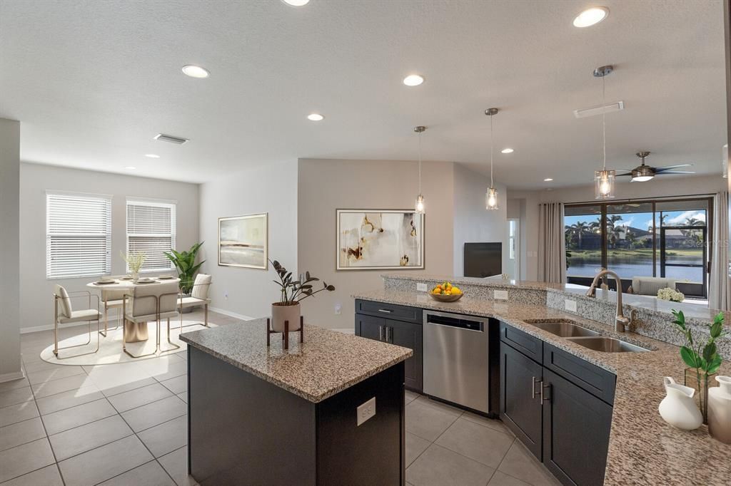 Breakfast bar and dinette area is ideal for everyday meals.  Staged photo.