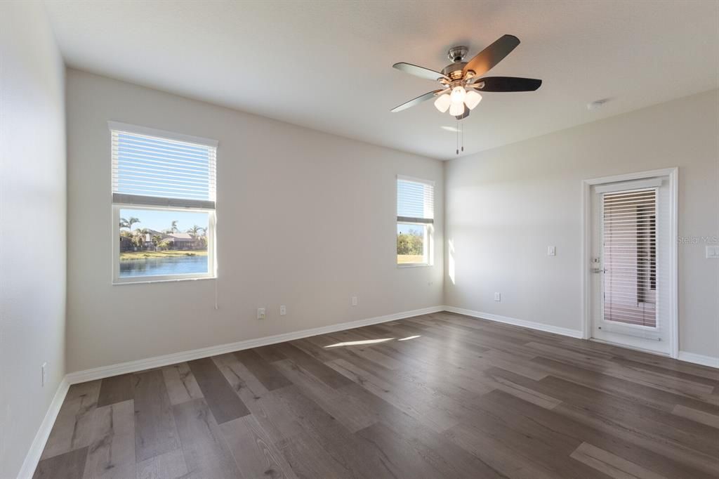 Primary bedroom offers easy acces to the screened lanai.