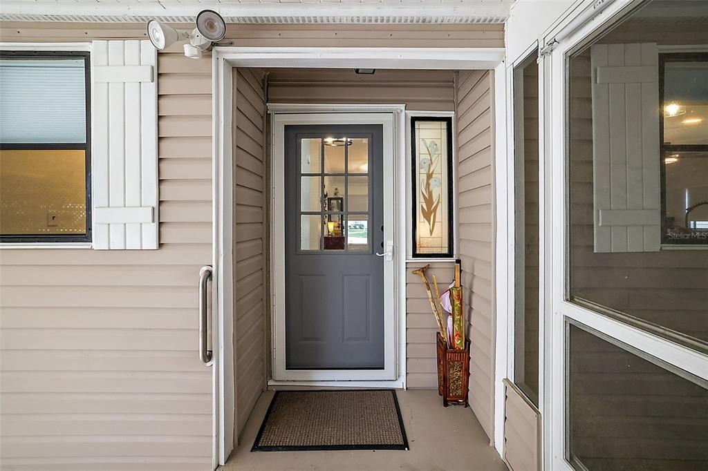 Beautiful front door with new storm door.