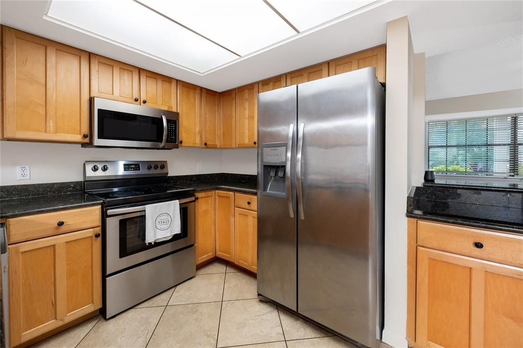 Shaker cabinets with stainless steel appliances.