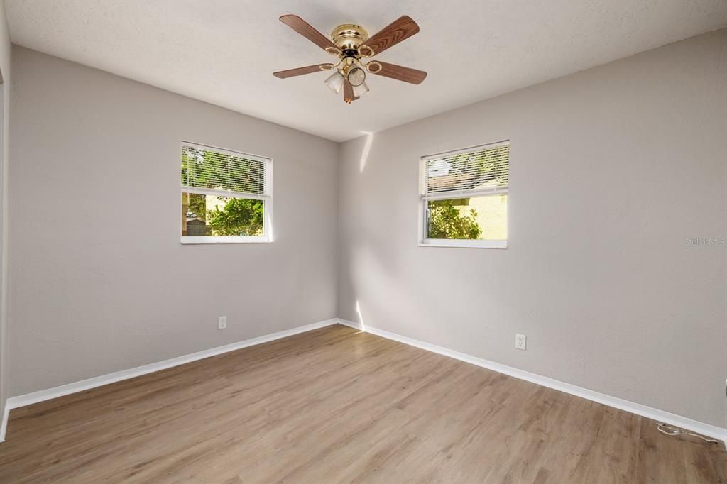 The second bedroom is a corner room at the back of the house. It has a windows that let in lots of natural light.