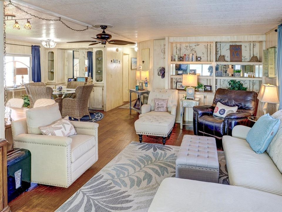 Living room with view of the dining room and hallway leading to the bedrooms.