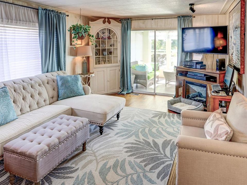 Living room with view of the screened back porch.