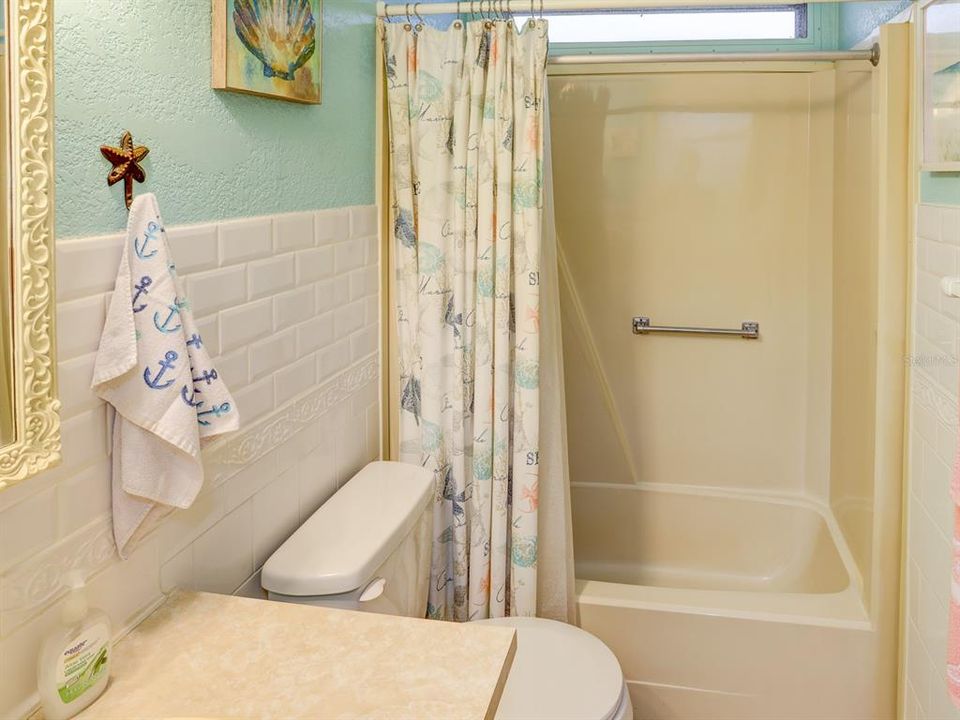 Hall bath with tiled walls.