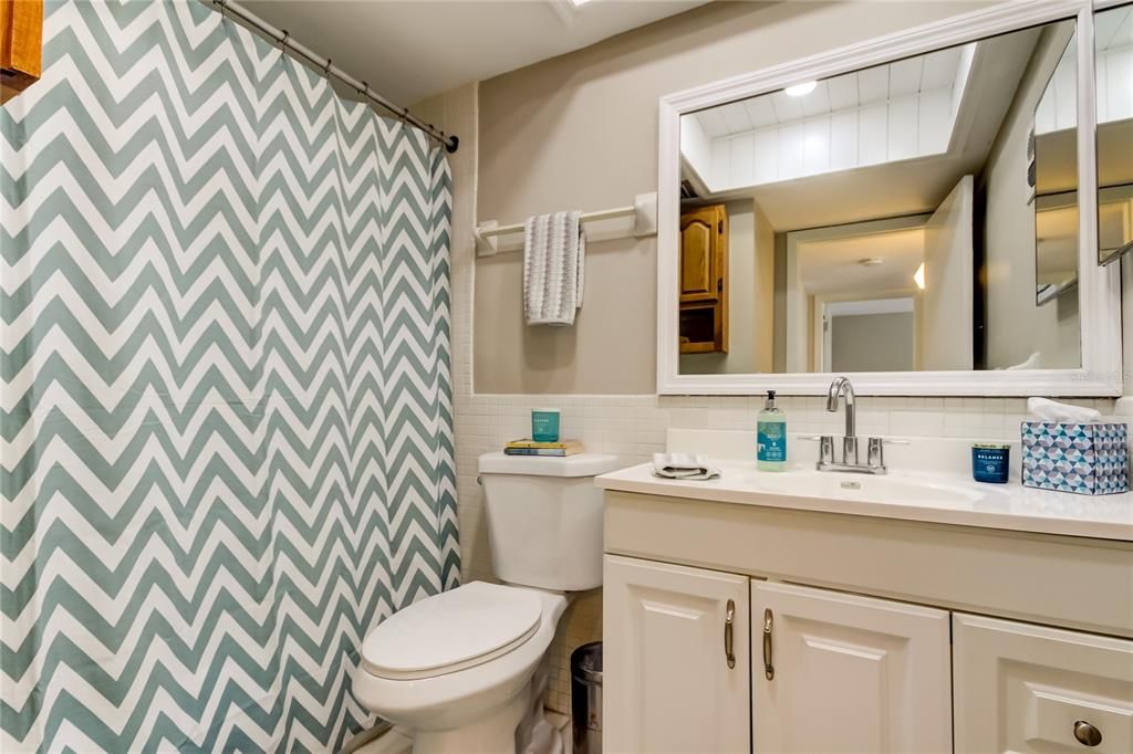 40. Bathrom has Multiple Towel Racks.. a Storage Cabinet on Opposing Wall, Framed Mirror!