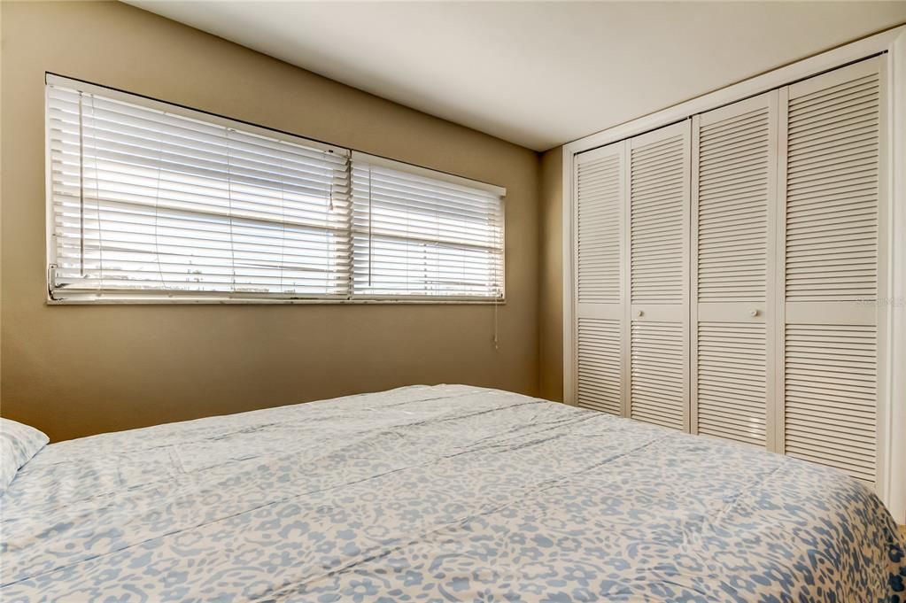 42. Bedroom #1 (14.4' x 10.2') w Mini Blinds, Freshly Painted Walls & Closet Doors!