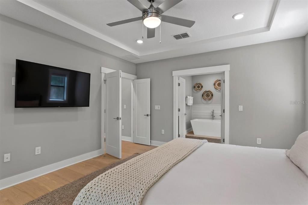 The primary bedroom has a bathroom with a soaking tub.