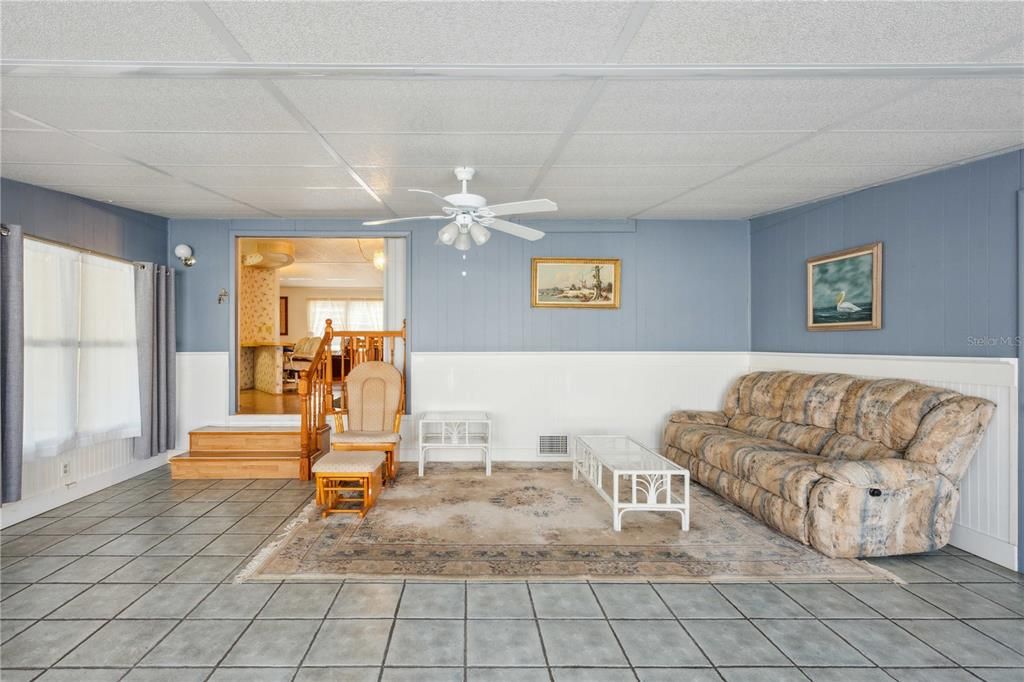 Tile flooring, double pane windows, and ceiling fan.