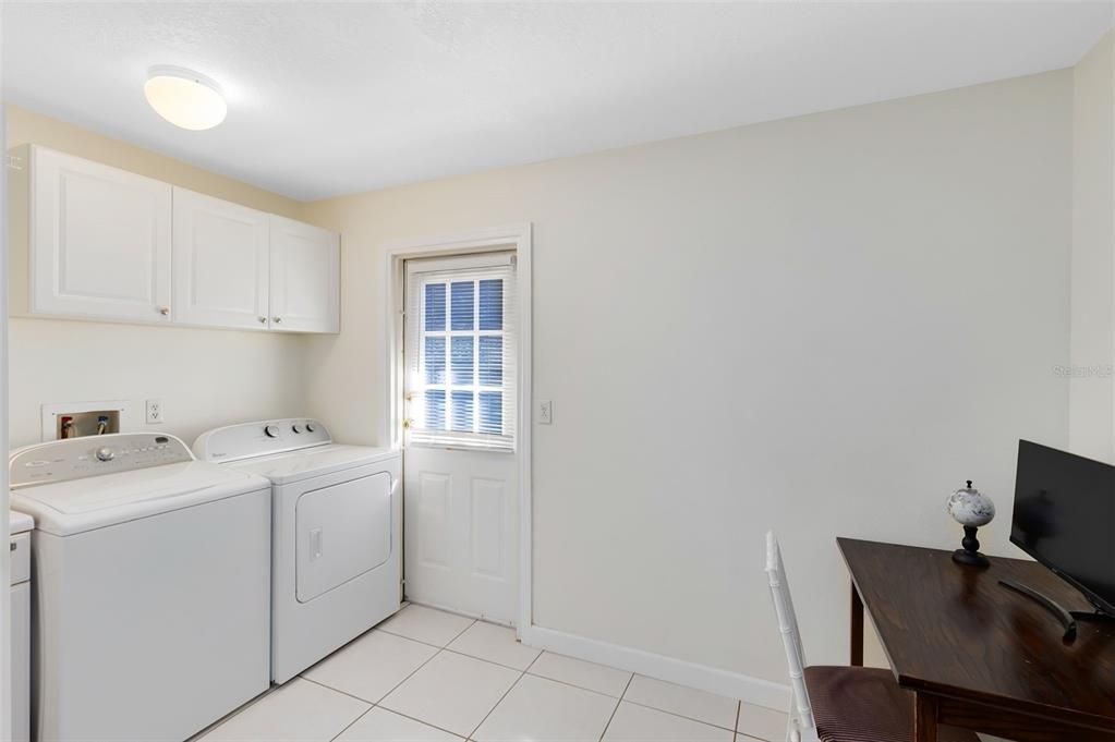 Laundry Room / Office + powder bath with dedicated side entrance.