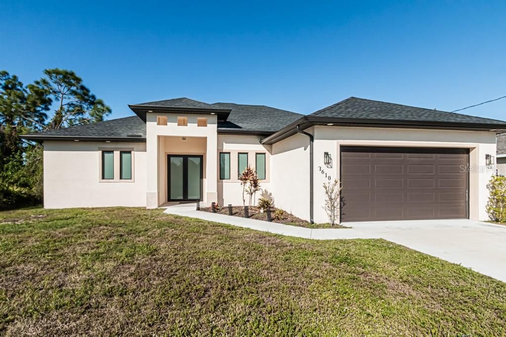 Home exterior featuring paved driveway and 2 car garage