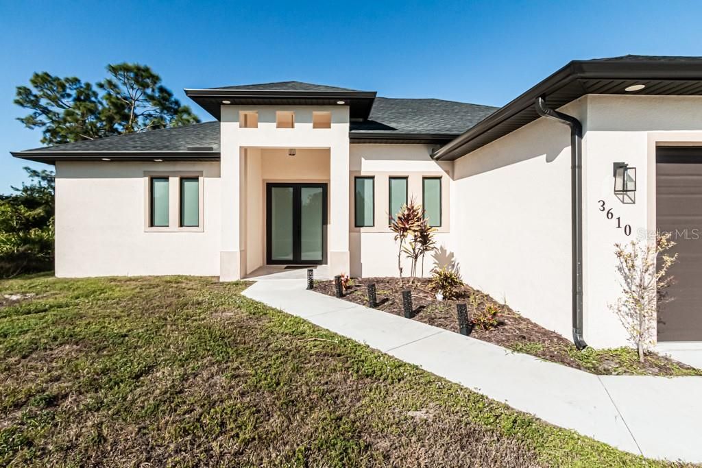 Entrance featuring double glass doors.