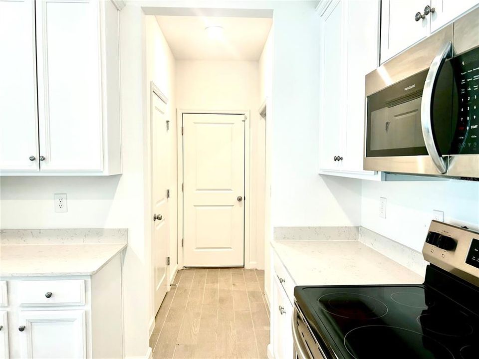 Kitchen to Half Bathroom, Laundry Room, and Inside Garage Door Entry