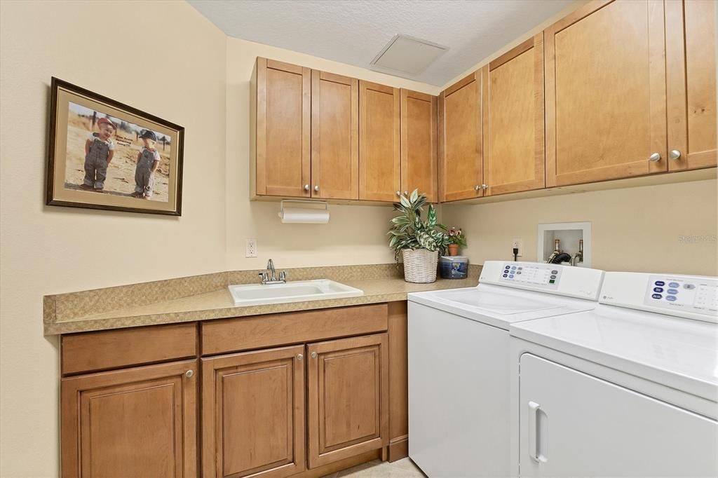 Separate laundry room with a storage closet