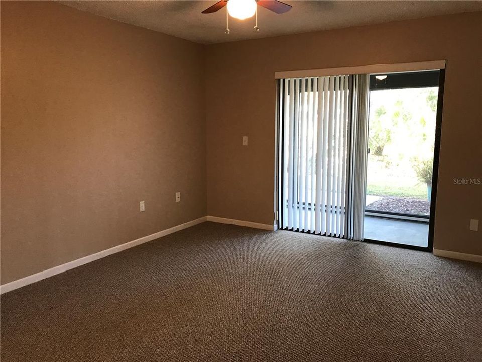 MASTER BEDROOM with double slider opening out to enclosed Lanai