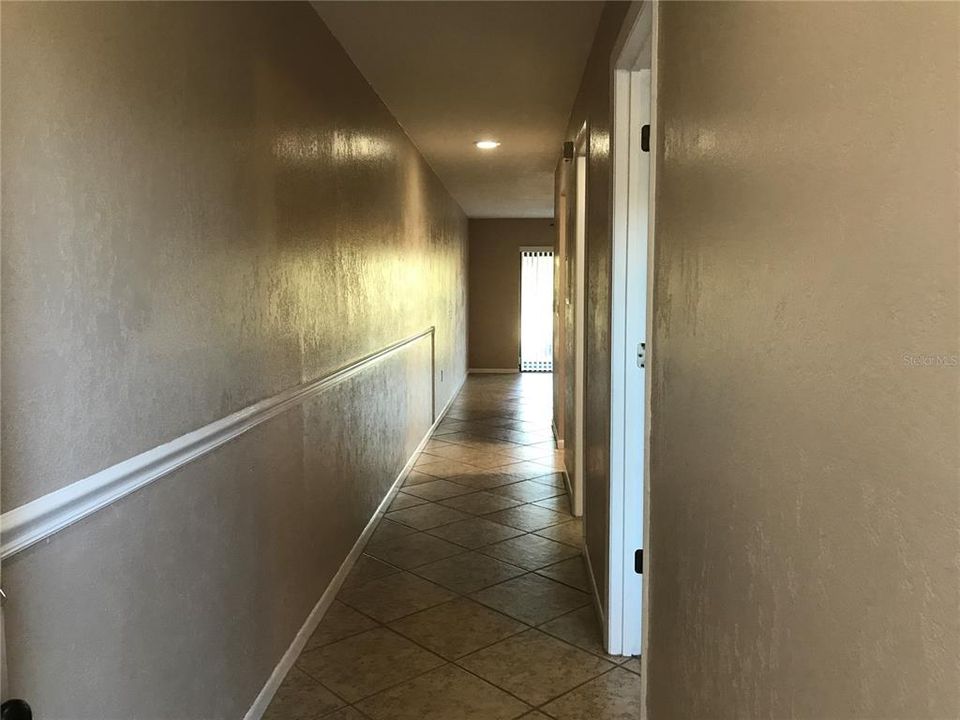 TILED HALLWAY LEADING INTO CONDO