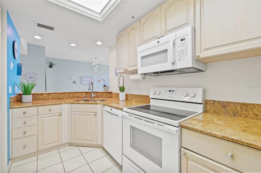 Kitchen with granite counters and lots of cabinets.