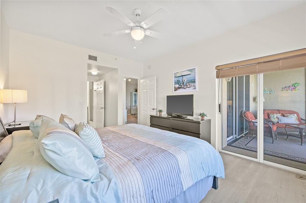 Primary bedroom with access to balcony.