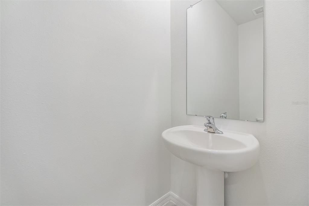 Downstairs half bath with pedestal sink!