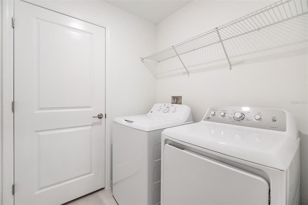 Upstairs interior laundry room with shelf above