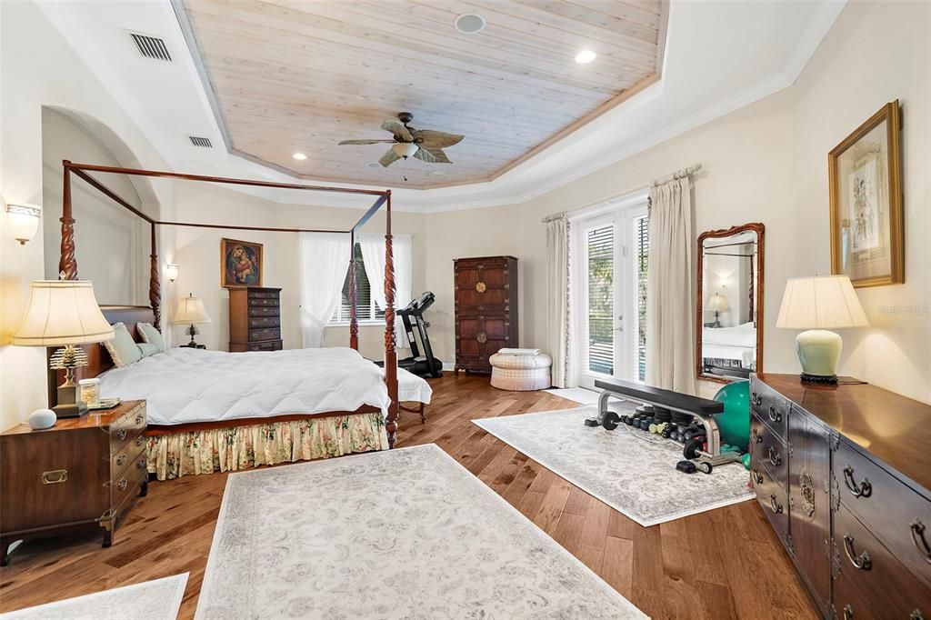 Primary Bedroom with double doors leading to Pool.