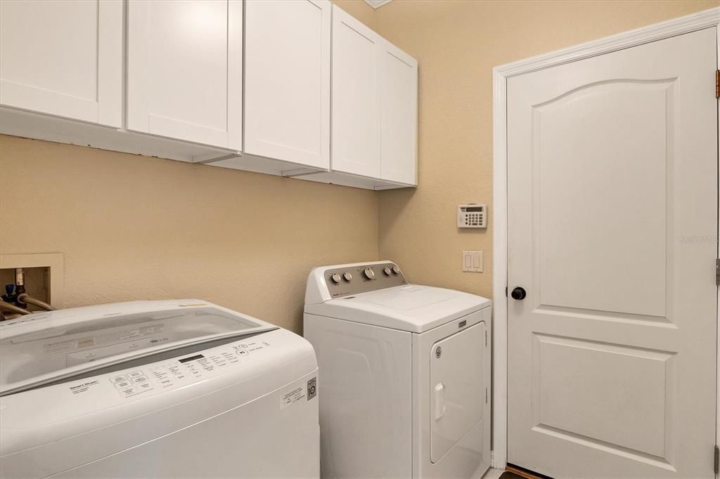 inside laundry with storage