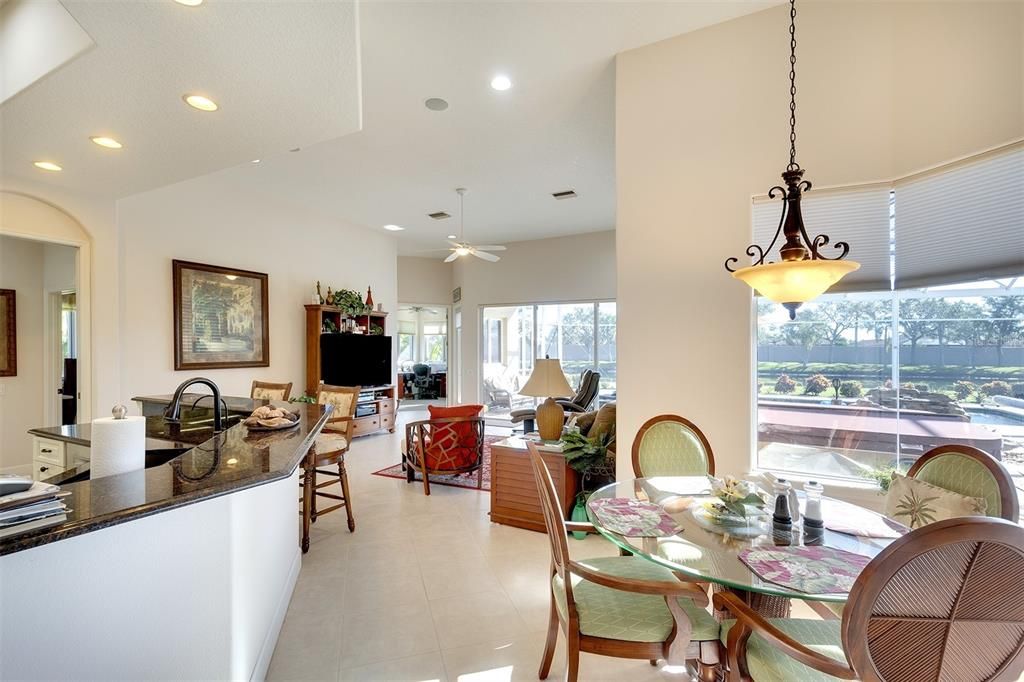 Granite countertops in the kitchen with breakfast dining area.