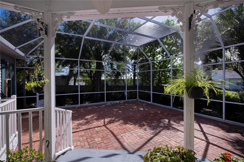 Gracious brick paved patio lanai as you leave the informal dining area.