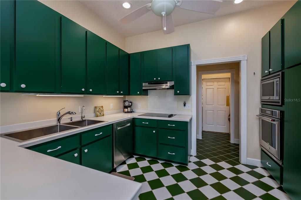 Through the opening is a butler's pantry leading thru the swinging door to the formal dining room.