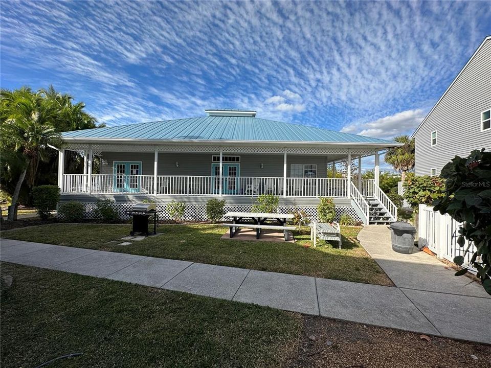 Clubhouse.  Note the picnic table, chaise lounges, grill, furniture on the porch, etc.