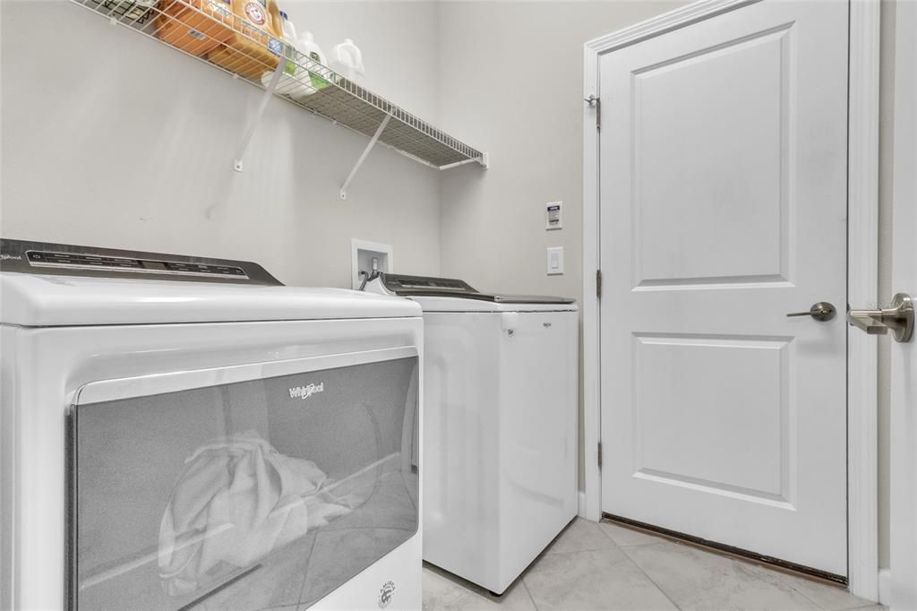 Washer/Dryer will convey upon sale of property. Door leads to garage.