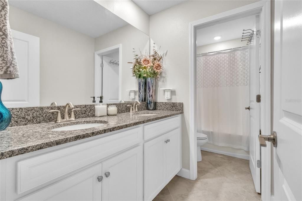 Full bath with dual sinks serves the two secondary bedrooms on this level.