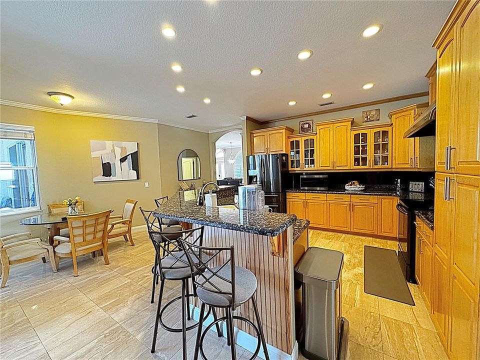 Chef's dream kitchen with kitchen table and countertop stools.