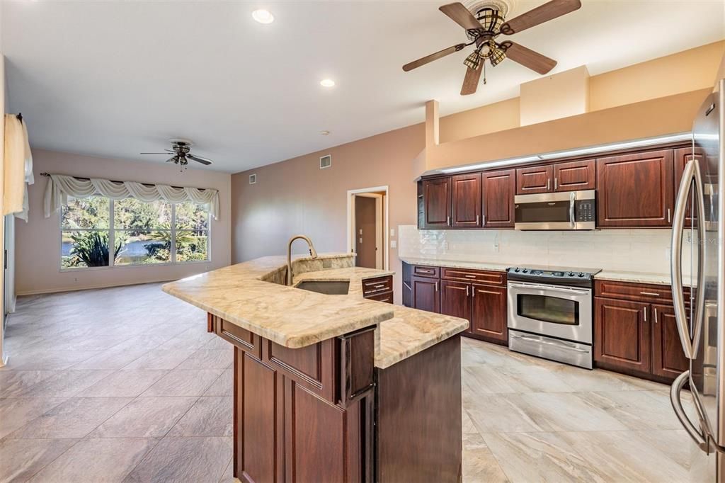 Great use of space in the large kitchen and family room with pond views