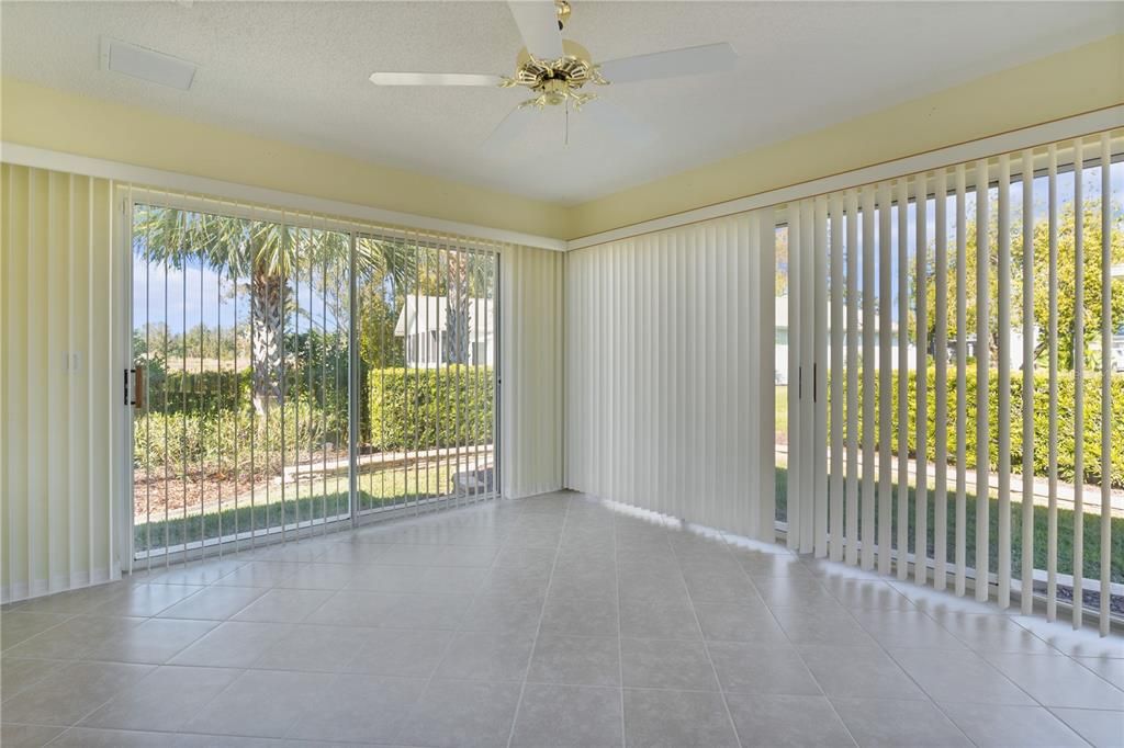 The 12 X 13 glass-enclosed Florida Room is a versatile space with heat and air and sliding glass doors that open to the side yard.