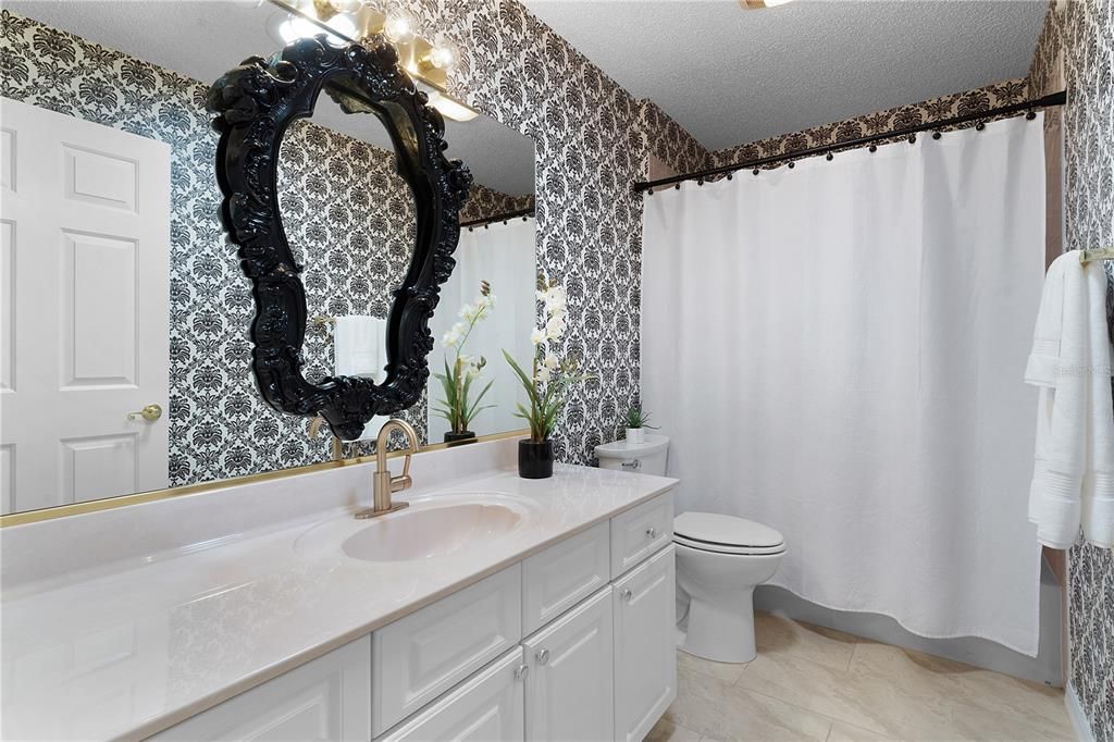 Stylish guest bathroom with solar tube and tub/shower combo.