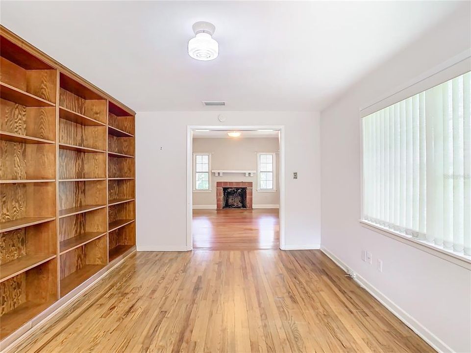 Den/office with built-in bookshelves. Fire place in the living room.