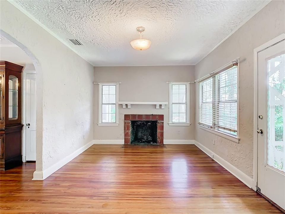 Living room with wood burning fire place.