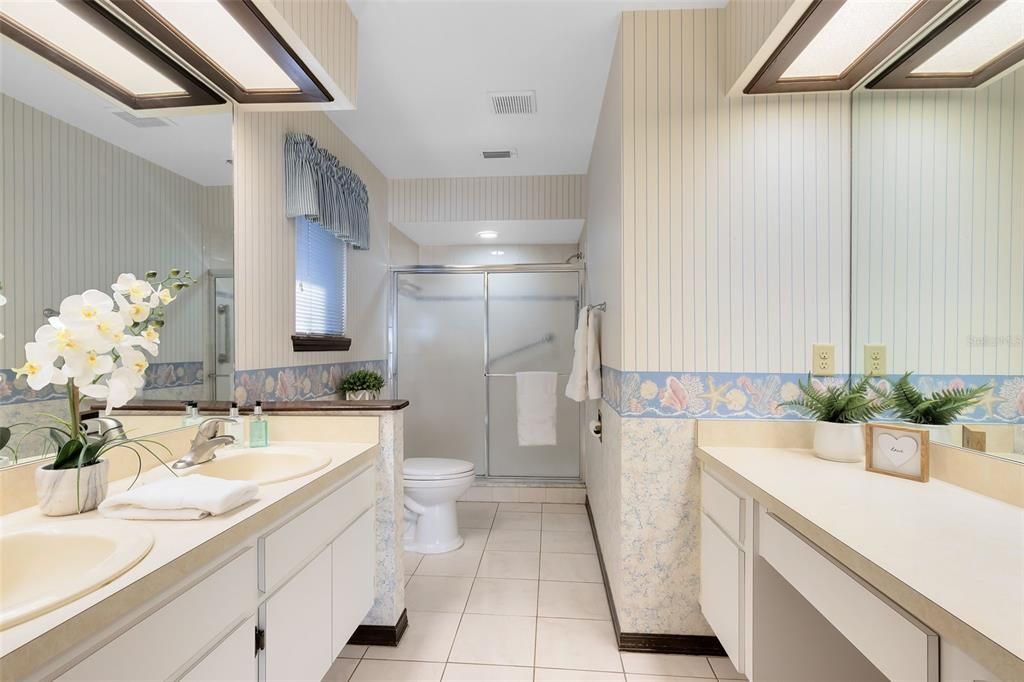 Large primary bathroom with a walk in shower and a lot of counter space