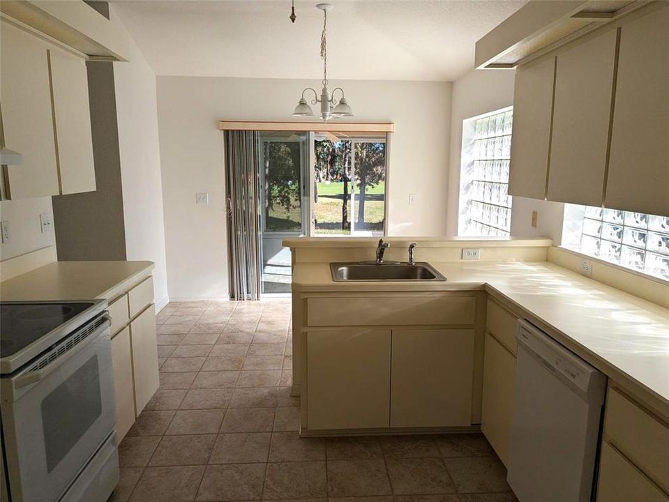 kitchen with eat in area opening to lanai