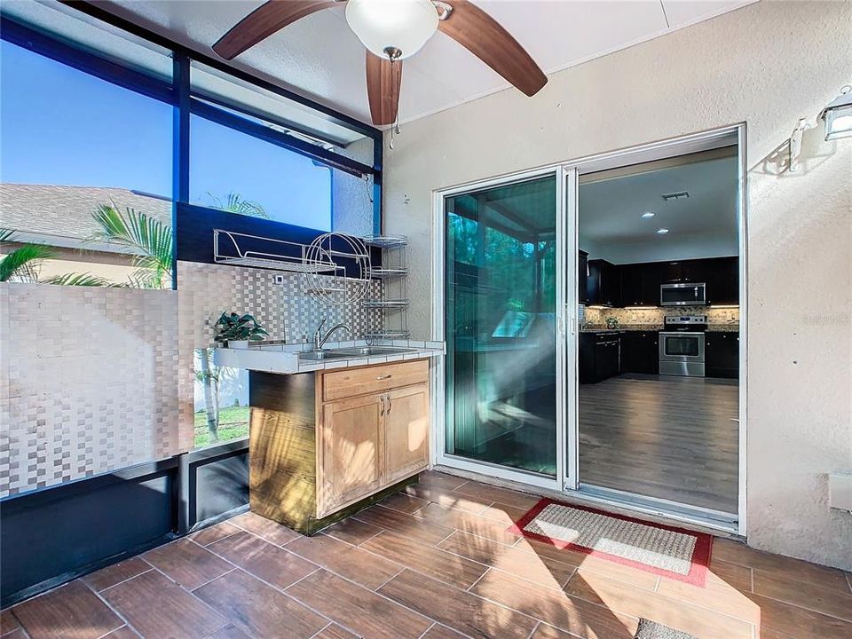 Sliding glass doors open to the screened patio