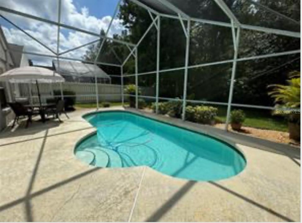 Nice size screened pool and patio facing the conservation.