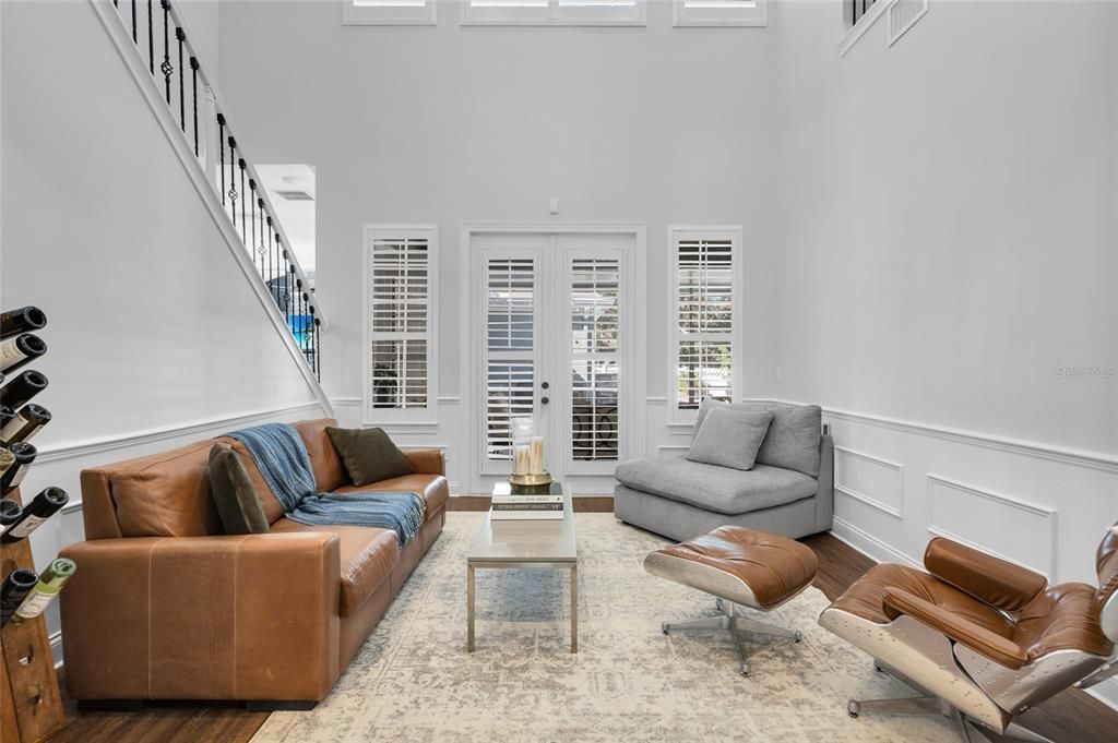 Living Room opens to  screened back porch & pool area